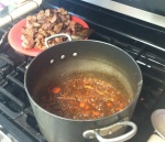 Vegetables simmering with beer. Meat waiting to dive in.